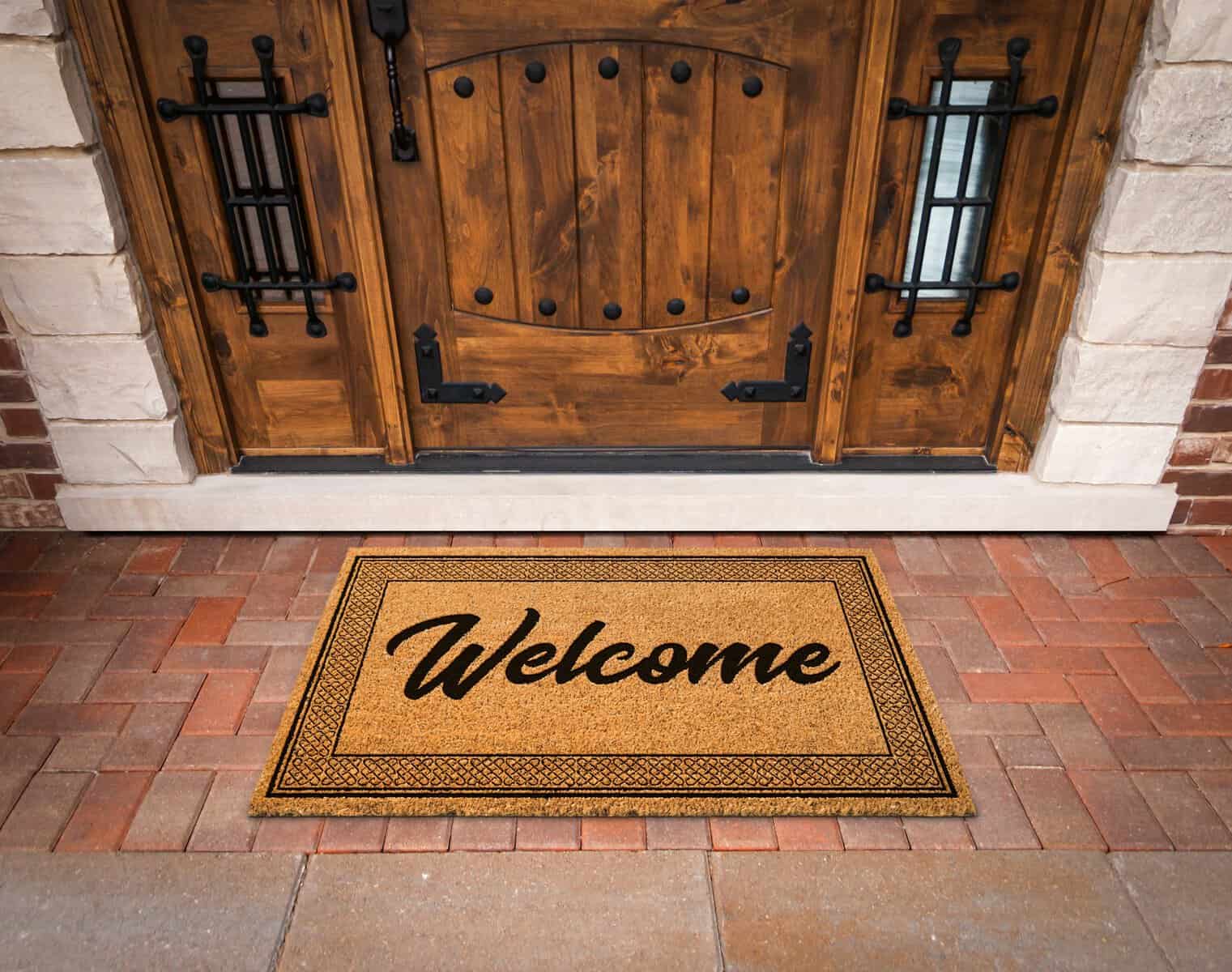 Welcome Mat At Custom Front Door Of House.